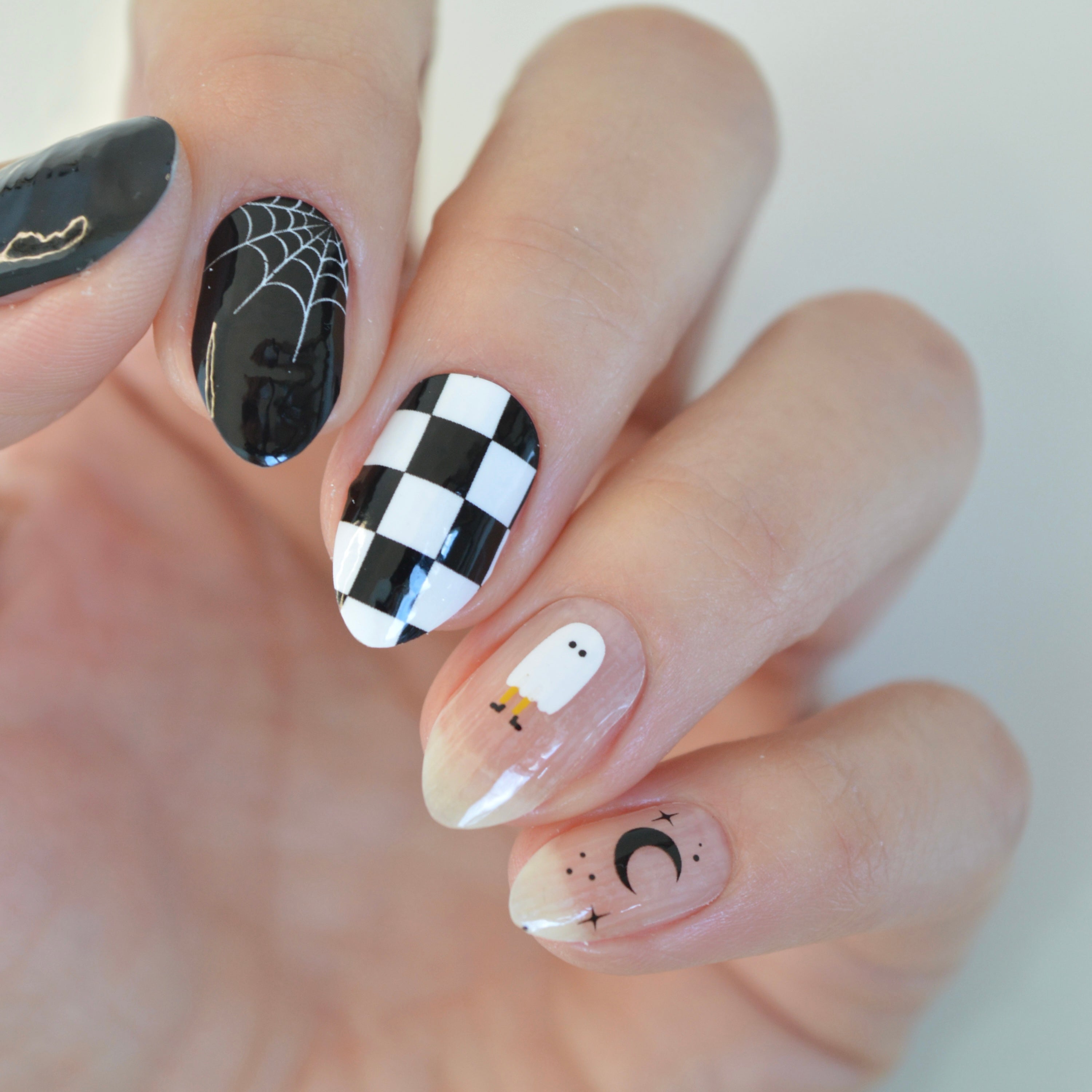 Casper black and white Halloween nail wraps on nails