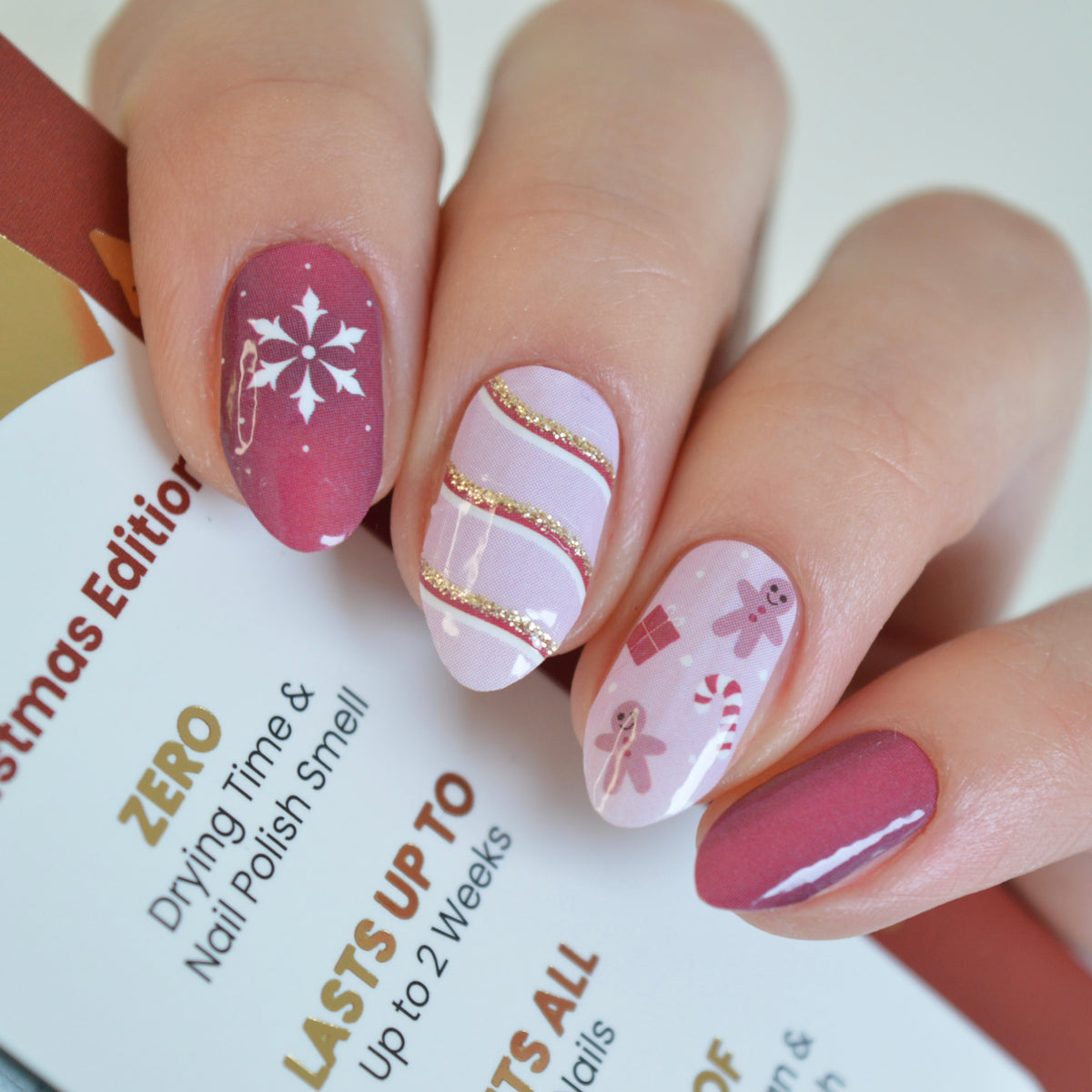 Christmas Eve berry red and pink Christmas nail wraps on nails